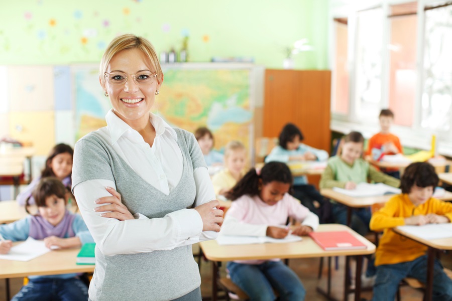 Smiling teacher at the school class