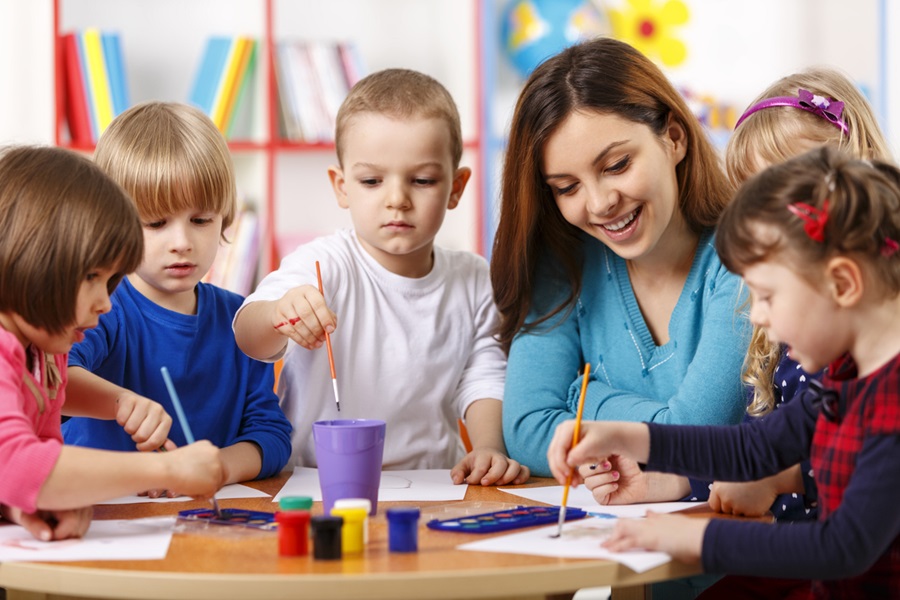 Group Of Elementary Age Children In Art Class With Teacher